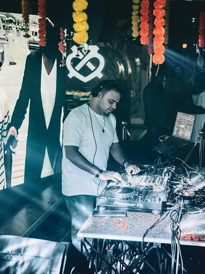 Mixing tracks with the VJ screen showing visuals in the background. This shot captures both the audio and visual elements of my performance.