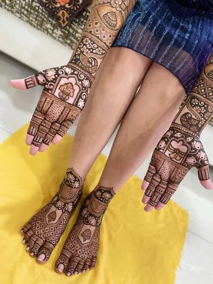 A complete bridal look is essential. Here is an example of my work covering both hands and feet with matching intricate patterns, including peacocks and traditional jharokha designs.