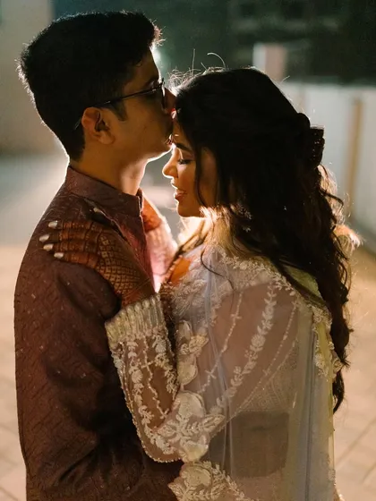 An intimate and romantic moment between the couple. The bride's makeup is flawless, even in this close-up shot.