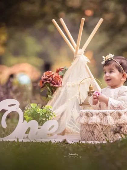A dreamy outdoor first birthday session. This little girl looks like a fairy-tale princess in a beautiful boho-chic setup with a teepee and lantern.