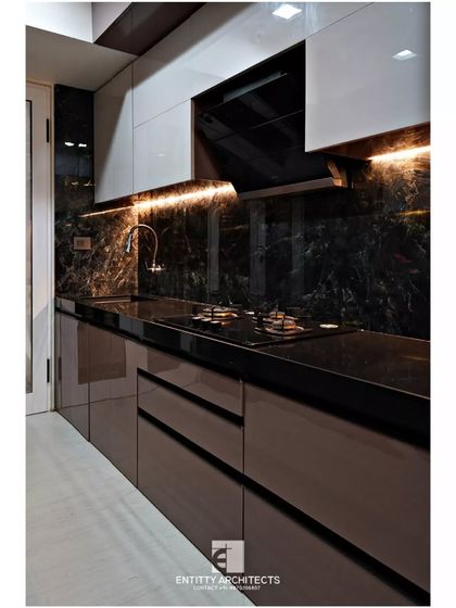 A closer view of the cooking area in the Pote Residence kitchen. The under-cabinet LED lighting highlights the black marble backsplash and provides excellent task lighting for the countertop.