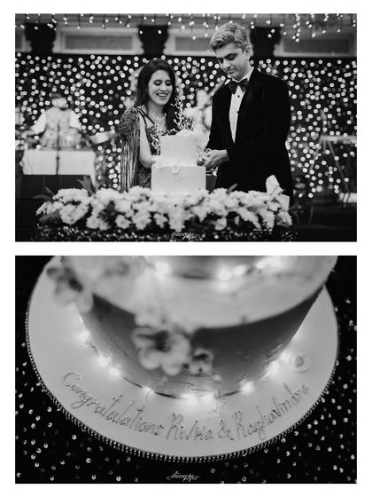 The cake cutting ceremony, a sweet tradition during the reception, captured in timeless black and white.