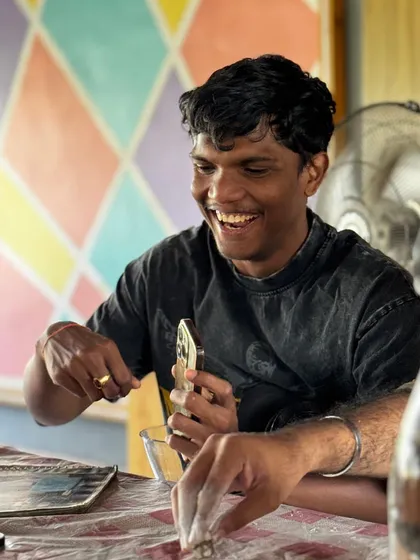The pure joy of creating. A participant laughs while working on his project, capturing the fun and relaxed atmosphere of our workshops.