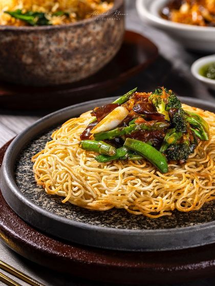 Crispy pan-fried noodles with vegetables, a signature dish at Shang Palace.