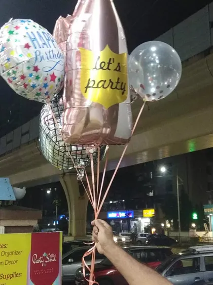 Ready to get the party started? Our helium-filled balloon bouquets, like this one with a champagne bottle and disco ball foil, are perfect for any celebration. We can deliver them right to your party in Kharghar.