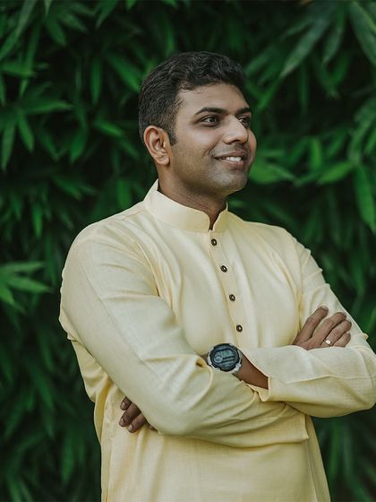 A handsome portrait of the groom in his yellow kurta, ready for his Haldi ceremony.