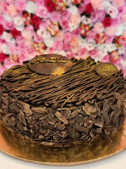 Another look at my exclusive Brownie Cake. The intricate piping work and dusting of gold give it a premium look, while the inside promises a dense, chocolatey experience you won't forget.