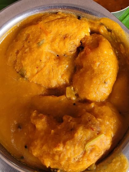 A close-up of our vadas soaking in a rich and hearty sambar, absorbing all the delicious flavors.