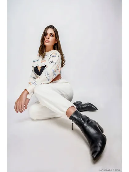 Style that speaks volumes. A full-length studio shot showcasing a casual, edgy fashion look against a clean white background.