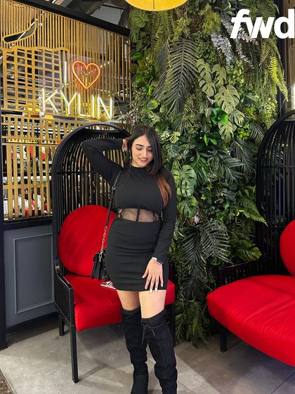 A chic all-black look from Myntra at Kylin restaurant. The mesh detail on the dress and knee-high boots make this a trendy and sophisticated choice.