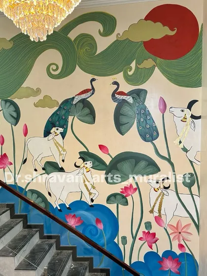 I love bringing our heritage to life on a grand scale. This expansive Pichwai mural flows up a staircase, filling the home with traditional elegance, featuring sacred cows, peacocks, and lotus ponds. Each element is hand-painted to tell a story of culture and beauty.