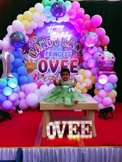 A happy moment captured at the Candy Land party, showing the birthday girl on her decorated stage.