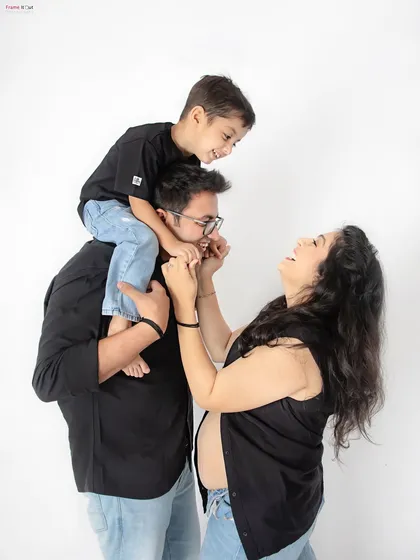 Pure, unscripted joy! I love capturing these candid family moments, like a big brother playing with his parents, all laughing together as they await the new arrival. These are the memories you'll treasure forever.