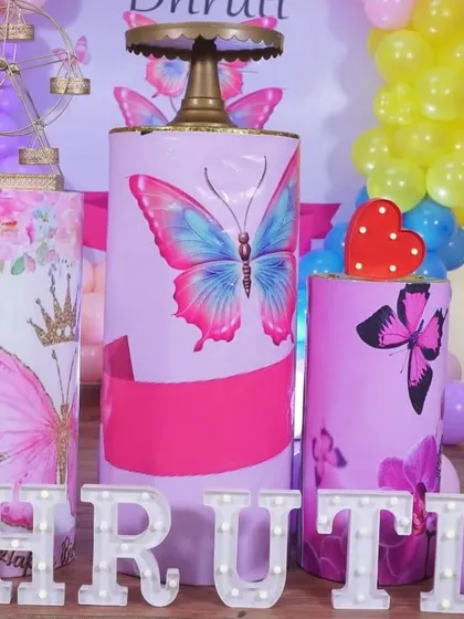 A close-up of the custom-printed pedestals for the butterfly theme party. The vibrant colors and sharp graphics really make the setup stand out.