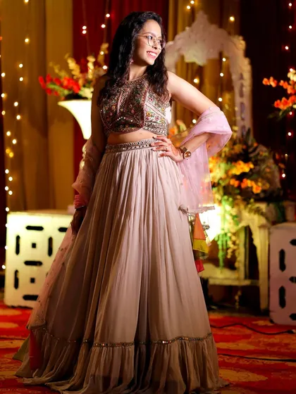 A guest poses in her beautiful lehenga against the event's decorated backdrop. I take time to capture stunning portraits of guests in their festive attire.