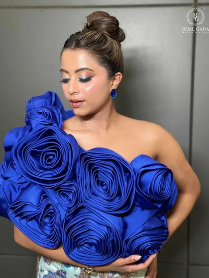 This shot highlights the flawless glass skin and the intricate details of the blue rose top. A truly unforgettable glow.