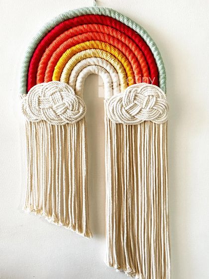 This rainbow features a warm, earthy color palette with reds, oranges, and yellows, grounded by a soft green. It feels like a beautiful sunset.