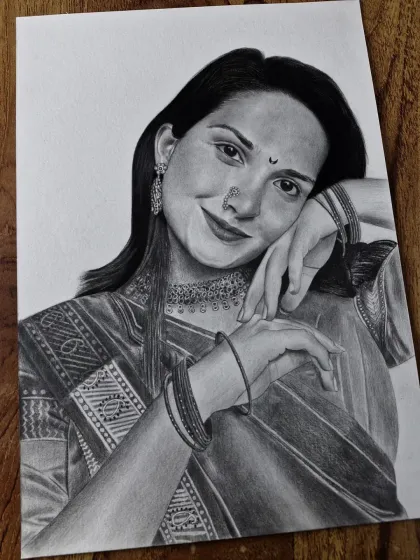 A close-up view of a portrait featuring traditional Indian jewelry and attire. This angle shows the detailed pencil work that goes into rendering the textures of the clothing and the shine of the ornaments.