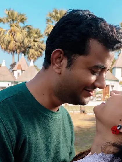 A beautiful close-up capturing a look of pure adoration. They are lost in their own world, smiling at each other, showcasing the simple happiness they find in just being together.