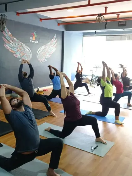 Our group yoga sessions are all about finding strength and alignment together. Here, we're moving through Anjaneyasana, a great pose for opening up the hips. Even in a group, we make sure everyone's form is on point.