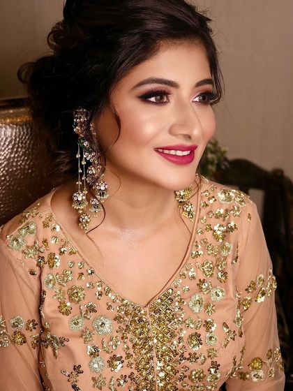 Another angle of this stunning party look. Her skin looks incredibly smooth and radiant, and the berry-toned lipstick adds the perfect touch of color.