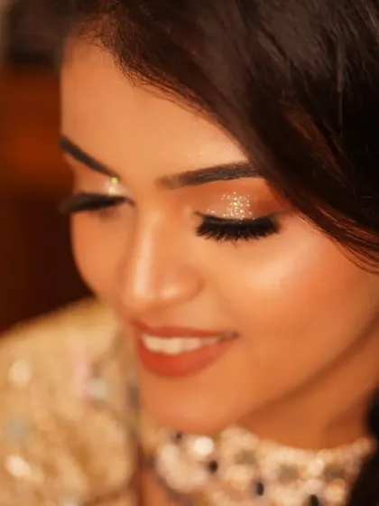 A close-up detail of the diamond glitter on Payal's eyelids. This macro shot shows the precision and artistry that goes into creating a truly sparkling reception look.