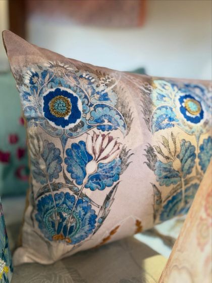 A beautiful floral printed cushion in shades of blue. The design is reminiscent of classic botanical illustrations, bringing a sense of timeless elegance and artistry to your decor.