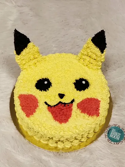 I choose you, Pikachu! This cake is shaped like Pikachu's adorable face, crafted with bright yellow frosting. It's a simple yet electrifying choice for any Pokémon fan.