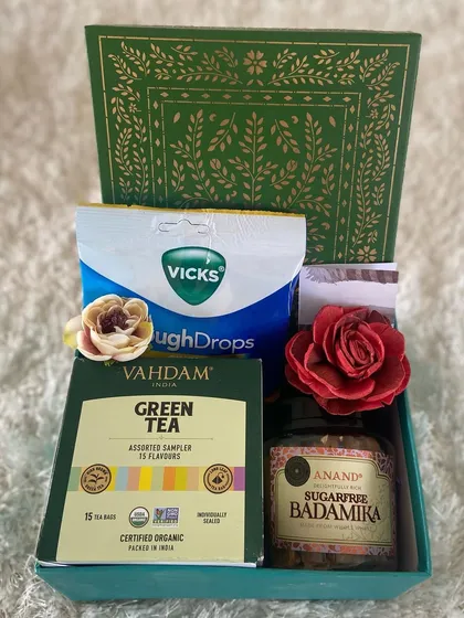 When someone you care about is feeling under the weather, a thoughtful care package can make all the difference. This simple yet effective get well soon hamper includes Vahdam green tea, sugar-free Badamika sweets, and Vicks cough drops to send a little comfort and warmth.