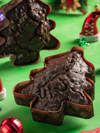 Christmas-themed tree-shaped chocolate cakes on a festive green background, perfect for holiday marketing.