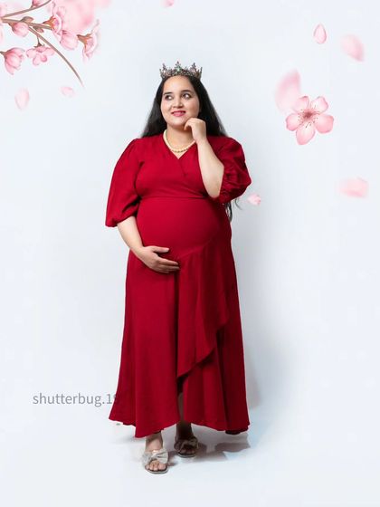 A sweet and simple portrait of a mom-to-be in a vibrant red dress. The crown and animated cherry blossoms add a touch of whimsy and celebrate the joy of her pregnancy.