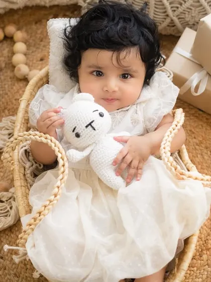 This little one is cuddling her stuffed bunny during her six-month milestone session.
