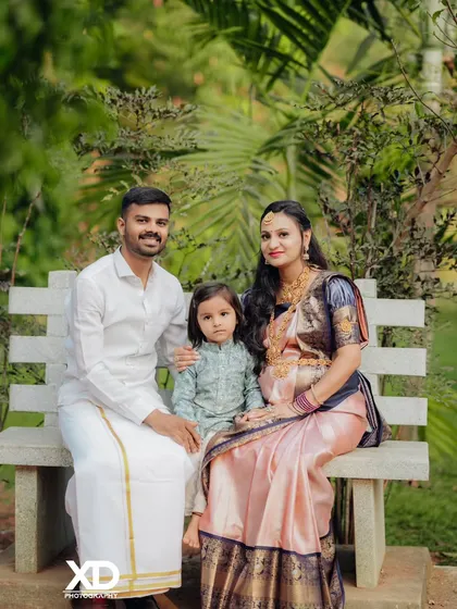 A beautiful family portrait on a park bench, capturing a memory before the new baby's arrival.