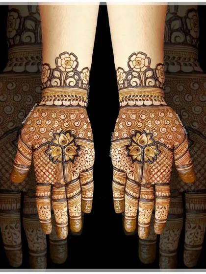 A beautiful design featuring a central lotus motif on the palm, surrounded by delicate patterns. The floral cuff on the wrist completes the look.