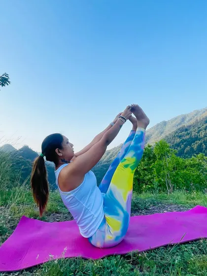 Engaging the core with Navasana, or Boat Pose. This asana is a powerful way to build abdominal strength and improve balance.
