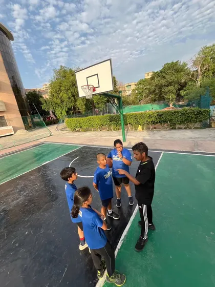 Personalized attention is at the heart of what we do. Here, I'm talking strategy with a small group of players during a practice game. These huddles are crucial for teaching game sense, building trust, and providing direct feedback.