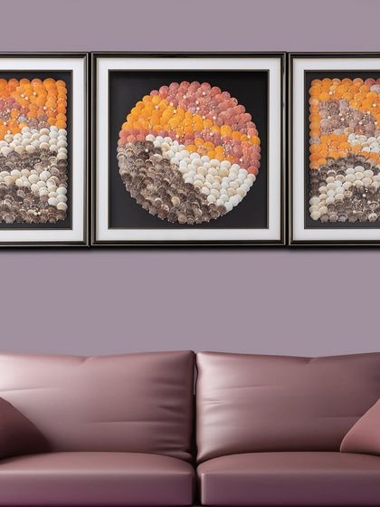 The 'Ocean's Rhythm' wall decor is a triptych shadow box made of real seashells arranged to mimic the abstract beauty of ocean waves. The warm, earthy tones bring a piece of the coast into your home.