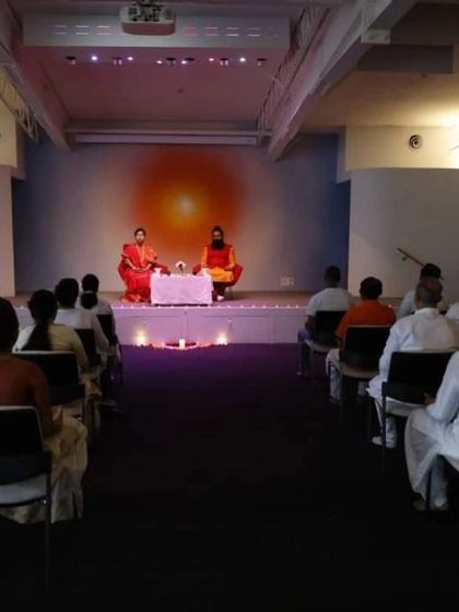 A wide shot of the meditation session in Sydney. This image, similar to 43, provides a broader view of the event space and the attentive audience.