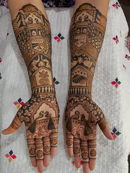 A full view of a traditional bridal mehendi, complete with auspicious symbols for a blessed marriage. The symmetry and detail are a testament to the care put into every design.