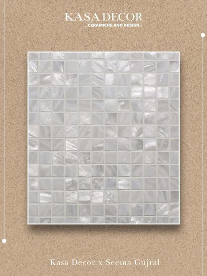 A close-up of our Mother of Pearl mosaic tile. The delicate shimmer and soft luminosity of the material create a gentle interplay of texture and reflection, offering beauty in its most graceful form.