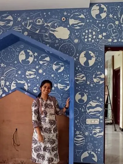 This was one of our most challenging and favorite kids' room projects. We filled the entire wall with a dense doodle of planets, stars, and astronauts. It was a lot of work on a ladder, but the result was a room full of wonder.