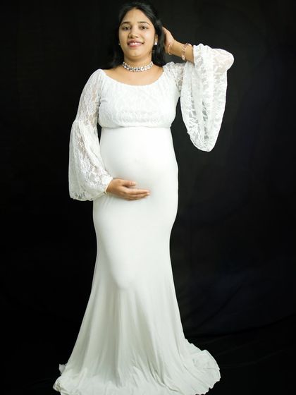 Another beautiful pose from the same solo session, showing how we can capture a variety of looks and moods. The mother-to-be gently touches her hair, looking serene and confident.