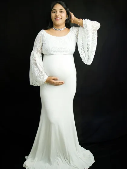 Another beautiful pose from the same solo session, showing how we can capture a variety of looks and moods. The mother-to-be gently touches her hair, looking serene and confident.