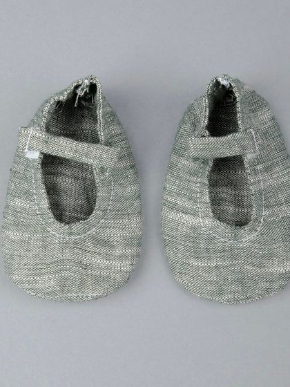 A product shot of the matching grey fabric shoes for the kids' ethnic set.