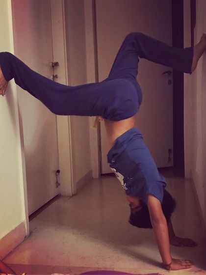 Learning to go upside down with the help of a wall. This supported handstand is a safe way for kids to build upper body strength and experience a new perspective.