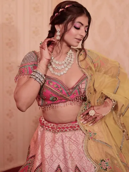 The full mehendi look, showcasing the multi-colored lehenga, diamond jewelry, and the fun, vibrant makeup.