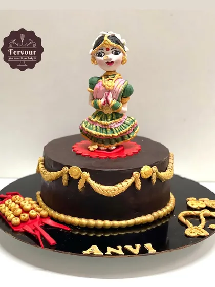 A Bharatnatyam dance theme cake. This chocolate truffle cake is frosted with rich ganache and features a detailed, hand-crafted fondant figure of a classical dancer.