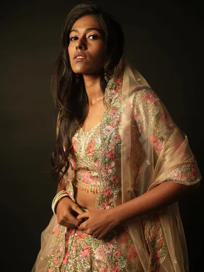 This shot showcases the beautiful floral lehenga and the soft, flowing hairstyle created for this editorial look.