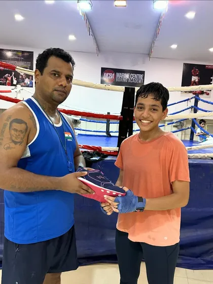 We believe in rewarding hard work. Here I am gifting a new pair of boxing shoes to our national-level boxer, Vedika Satre, for her achievements.