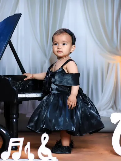 This little musician is ready for her concert in a beautiful black dress at our miniature piano.